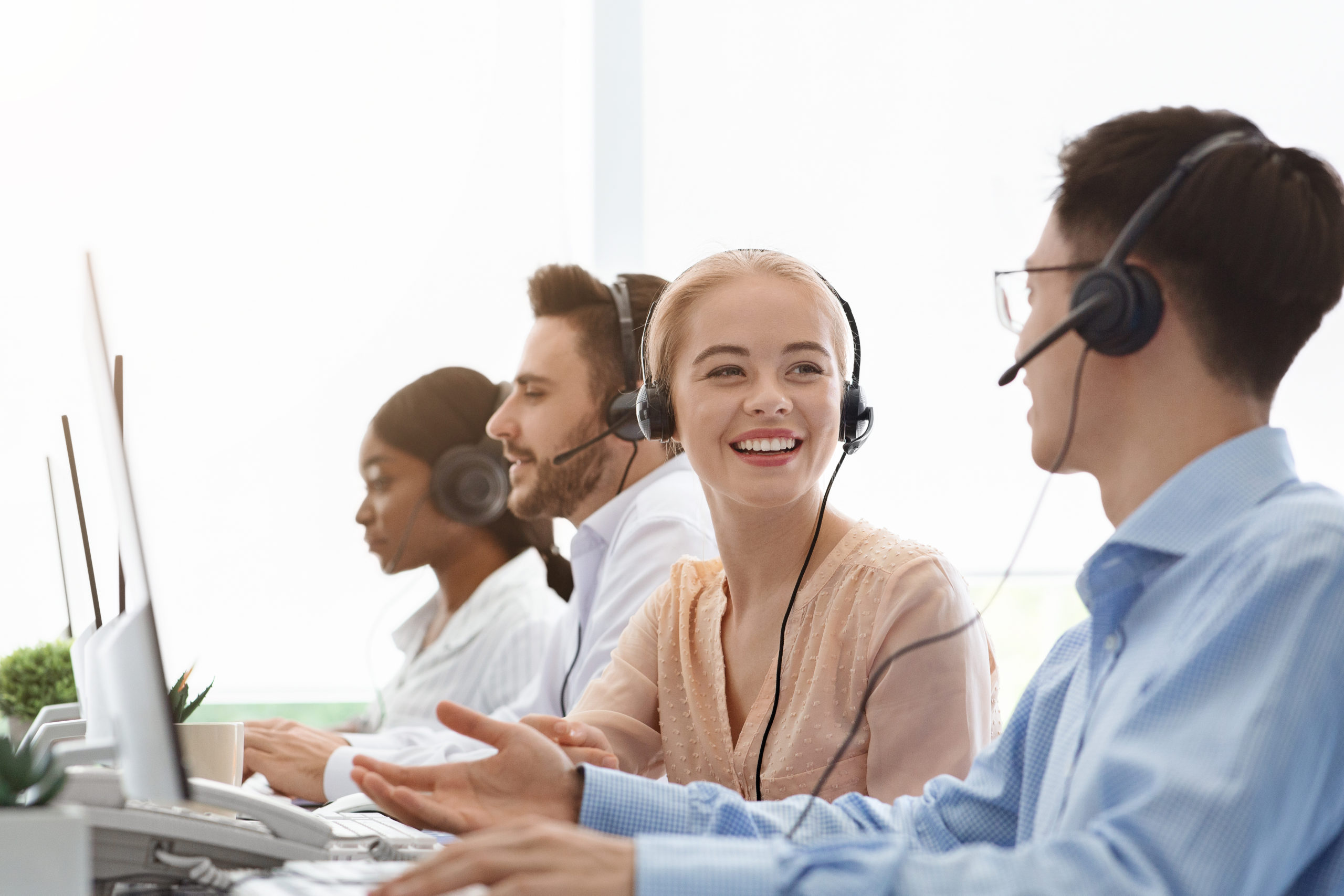 Call centre and customer service. Tech support operators discussing something at workplace